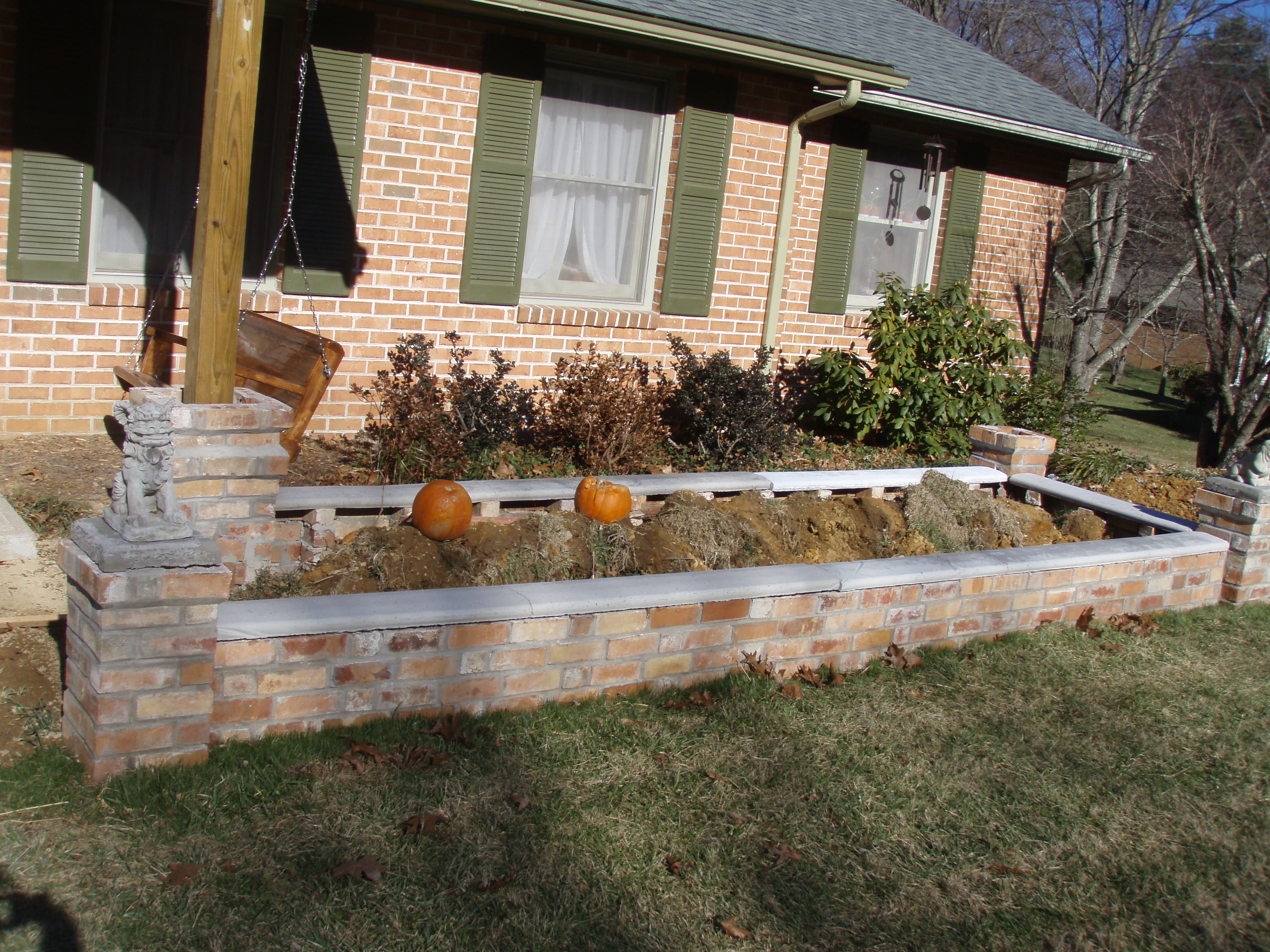 front gable porch with brick raised garden