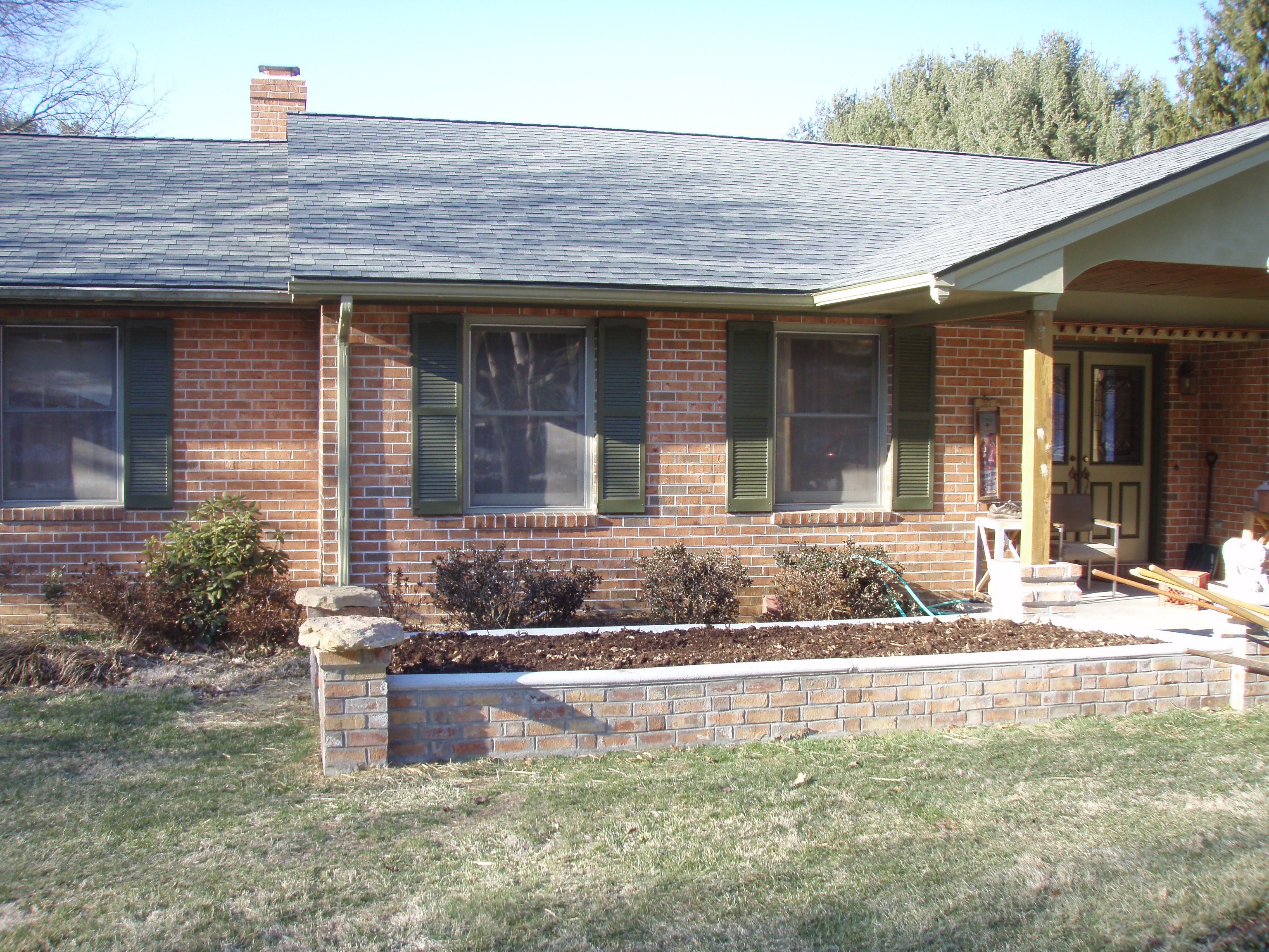 front gable porch with brick raised garden