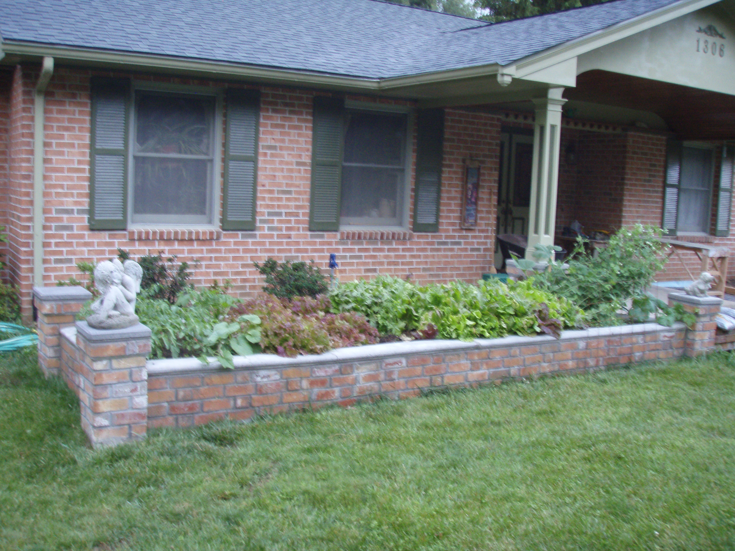 front gable porch with brick raised garden