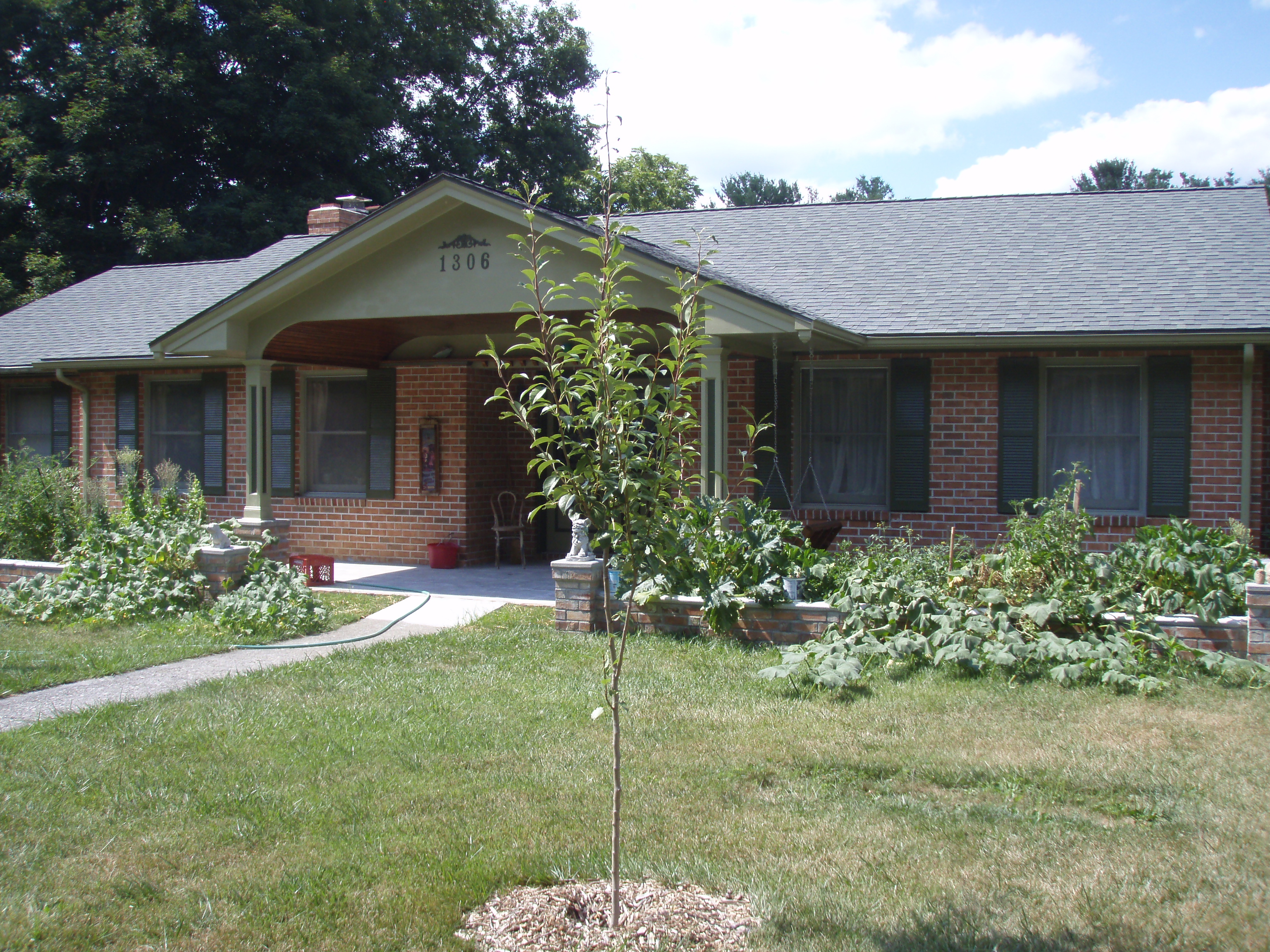 front gable porch with brick raised garden